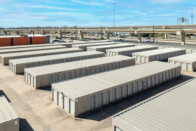 Self storage facility layout with rows of drive-up units and easy highway access nearby